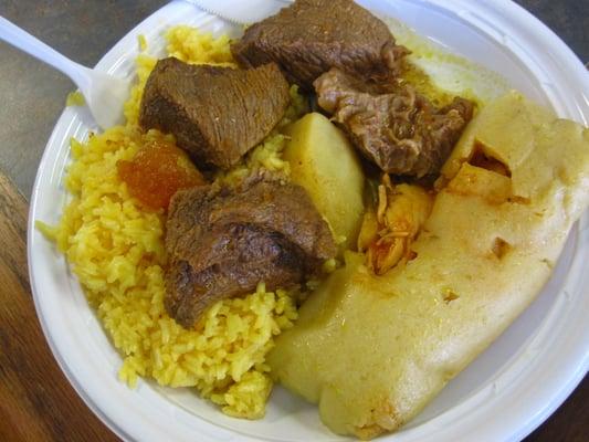 beef stew over yellow rice & chicken tamale - $5