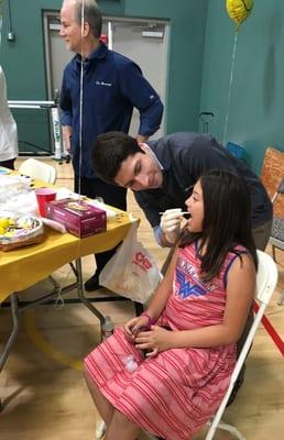 Dr. Jonathan doing a free oral health screening at YMCA Healthy Kids Day