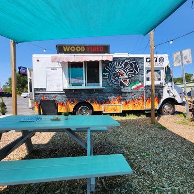 La Florizza pizza truck pictured from sitting at the picnic table.