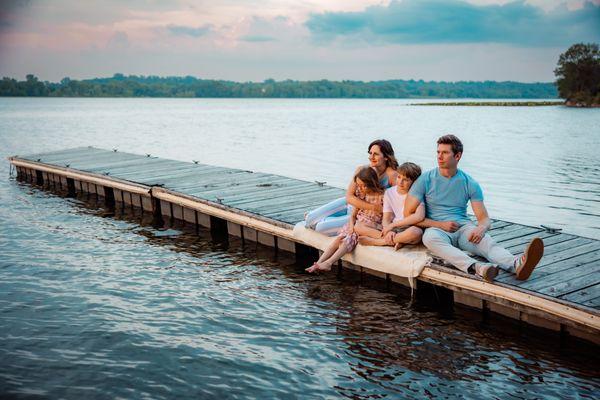 Family of 4 sitting on a dock