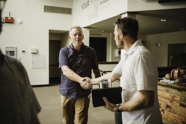 pastor greeting church members