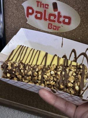 Banana Paleta with half dip dark chocolate and peanuts