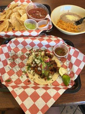 Al pastor, chips and salsa and side of rice & beans (no pictured is the steak taco I devoured)