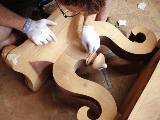 Careful hand sanding before this piece will be carefully stained and refinished, all by hand.