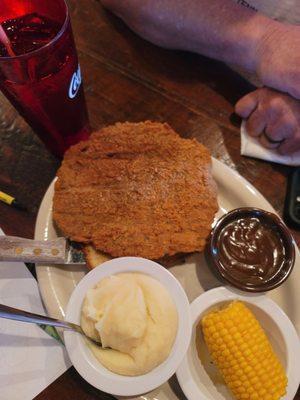 Country fried steak, mashed potatoes, gravy, and corn on the cob