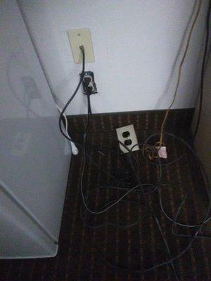 The only power outlet in the room, as I found it on checkin.