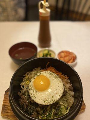 Bibimbap with 2 banchan sides (kimchi and cucumbers) and a side of soup