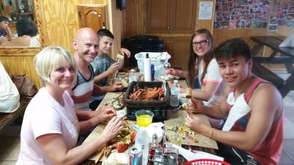 NICE YOUNG FAMILY FEASTING ON MARYLAND STYLE BLUE CRAB