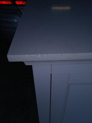 brand New special order vanity. Chipped top in several areas, foot print inside cabinet, defects on doors.