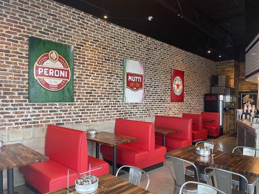 Custom red restaurant booth and American walnut wood table tops.