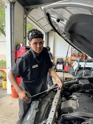 Alexander our Technician checking the oil before the new synthetic oil is put in. Julie A