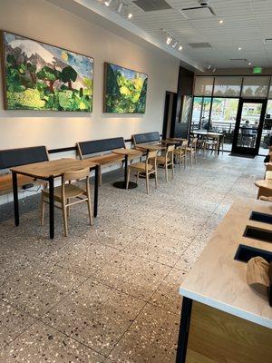 Tables along the wall have plugs to allow charging while eating.