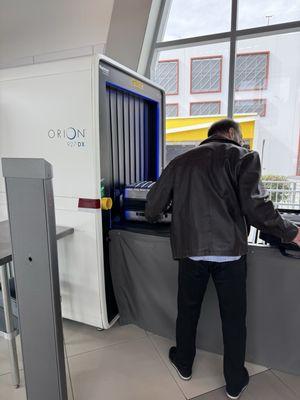 A man examining the security screening device.