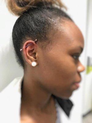 Pierced ear with jewelry. Almost Famous Body Piercing in Champaign, Illinois