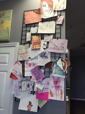 Our "wall of fame", pictures drawn for us by our girls!