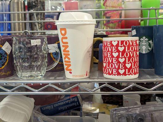 Someone left a Dunkin' Donuts carryout cup with the mugs. I thought it was a reusable cup made to look like a disposable cup, but it wasn't.