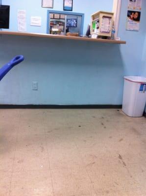 Dirty floor lobby at clinic. Needs a good wipe down.