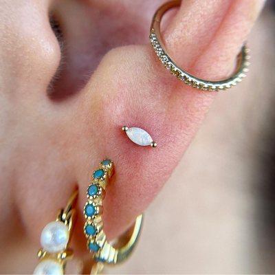 Fresh third lobe with Buddha Jewelry's yellow gold and genuine opal, "Zuri."