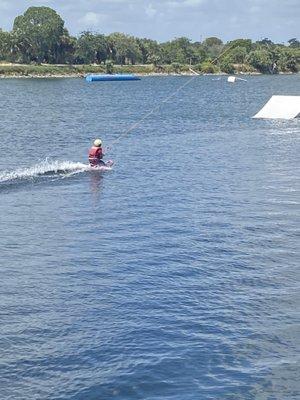 Kids wakeboarding for the first time.