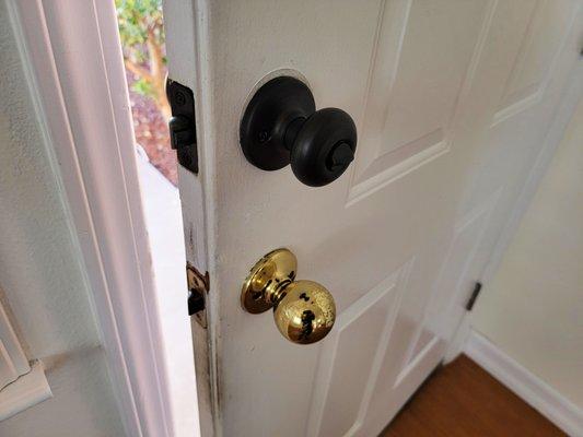 Two front door knobs is both a securty and emergency egress concern