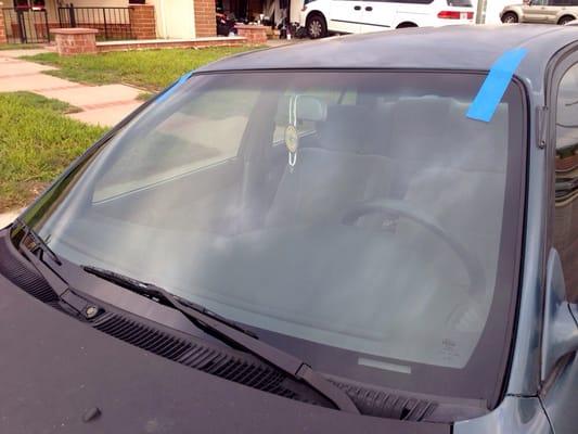 The finished product! Brand new windshield! The tape is to make sure the glue dries properly.