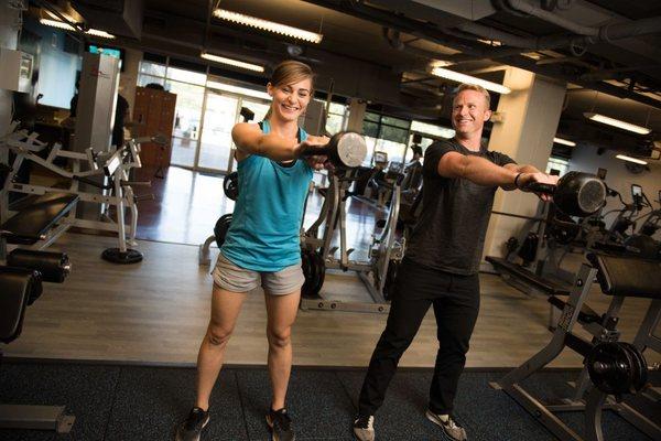 Robbie doing kettlebell swings with a client