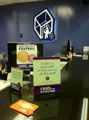 The sign at the desk where I've been waiting for someone to help me for ten minutes...no one here.