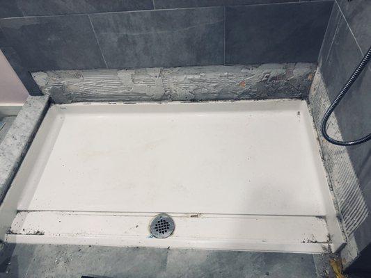 A picture showing the process having to remove the Bestbath defective shower pan.