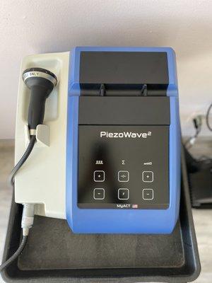 This is a shockwave therapy machine, which uses sound waves to stimulate healing around joints and muscles.