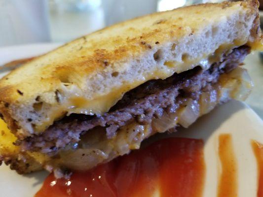 Patty Melt with American cheese and onions on rye bread. I like mine well-done. Delicious. It came with pickles and a side of chips.