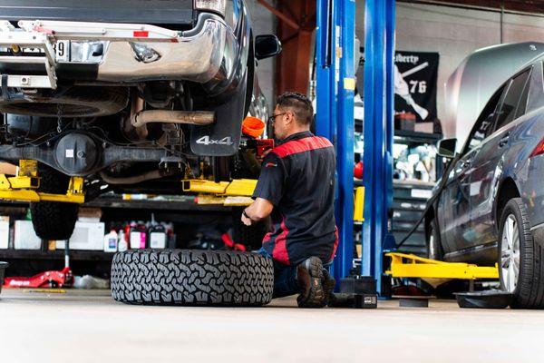 Our skilled technician working diligently on a vehicle repair, demonstrating our commitment to quality and reliability.