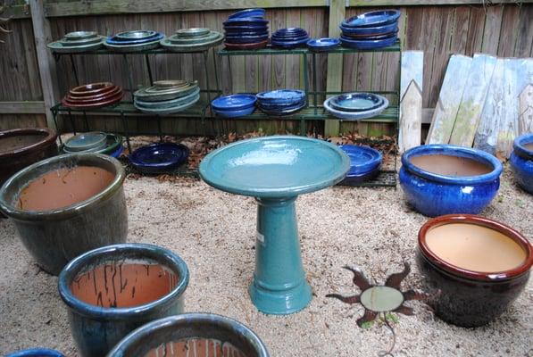 Glazed pots and birdbath.