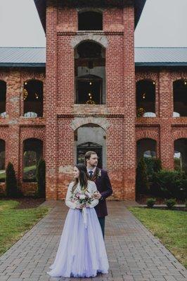 Couple standing in front of providence cotton mill