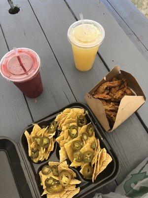 Berry smoothie and nachos topped with vegan cheese and jalapeños.  Fried mushrooms and a mint, ginger sea moss drink.