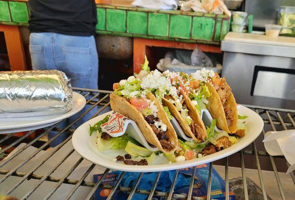 3 crispy tacos for $12 with burrito on the left.