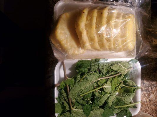 Picking up fixings for mojito and pina colada: mint and pineapple.