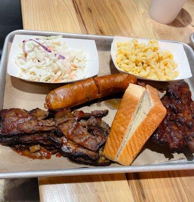 3 meats combo. Jalapeño and cheese sausage, brisket and ribs with sides of coleslaw and mac n (no) cheese.