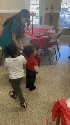 Toddlers enjoying the Valentine's Day  dance celebration.