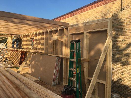 Exterior walls going up; Framing install after a couple trees fell on an owners house during a tornado.