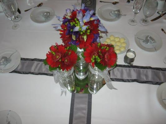 Bridal bouquet and two bridesmaid bouquets used as center piece for head table after ceremony.