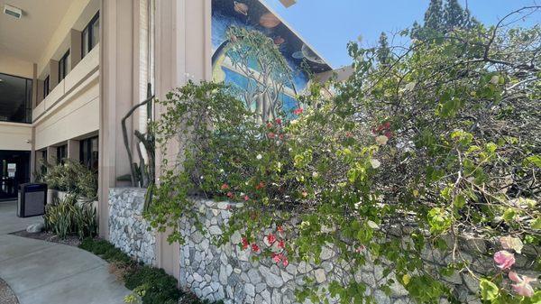 Cool Mural unfortunately hidden by plants.