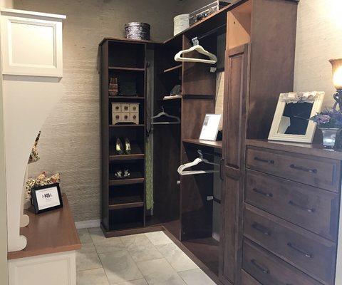 Stained birch closet system display, along with painted mud room display on left.