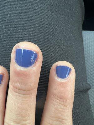 Uneven application of polish and poorly trimmed cuticles.  Nails were filed way too short.