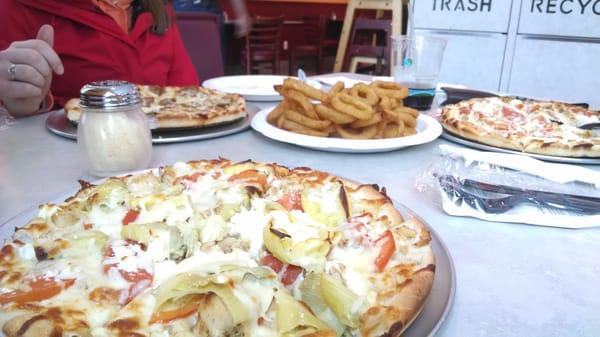 Chicken Artichoke pizza, onion rings, Bianca pizza, and Millo's pizza.