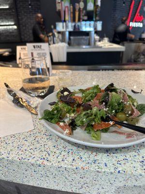 Nahom in the background.  Rosé & Mediterranean salad in the foreground.