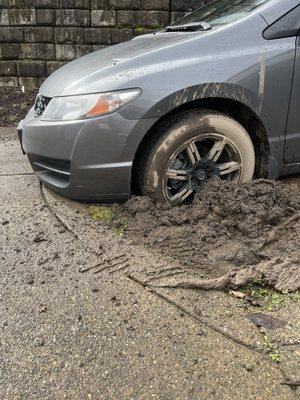 Front driver wheel sunken in mud