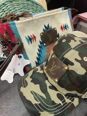 Louis Vuitton clutch purse and camouflage hat