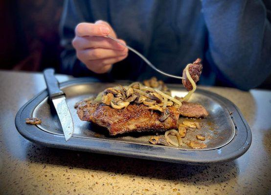 The New York Steak with sauteed Onions and Mushrooms