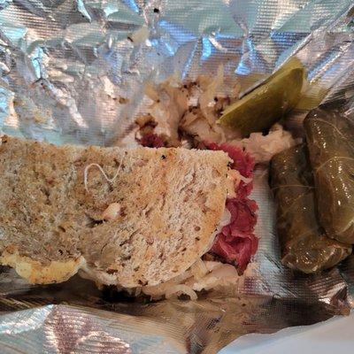 Reuben Sandwich with grape leaves on the side