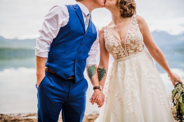 Couple kissing with bride in an expertly altered wedding dress.